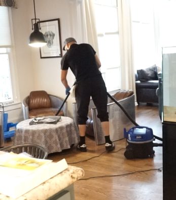 Cleaner Using Vacuum Cleaner on Floor
