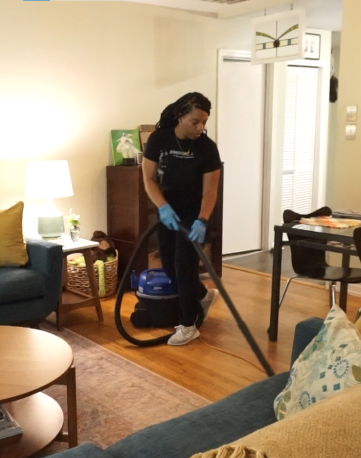 Cleaner Cleaning the Floor with Vaccum Cleaner
