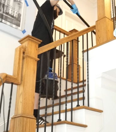 Cleaner Using Vacuum Cleaner on Stairs