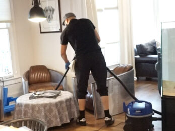 Cleaner Using Vacuum Cleaner on Floor