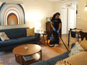 Cleaner Cleaning the Floor with Vaccum Cleaner