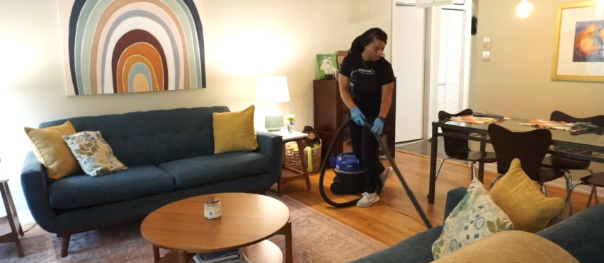 Cleaner Cleaning the Floor with Vaccum Cleaner
